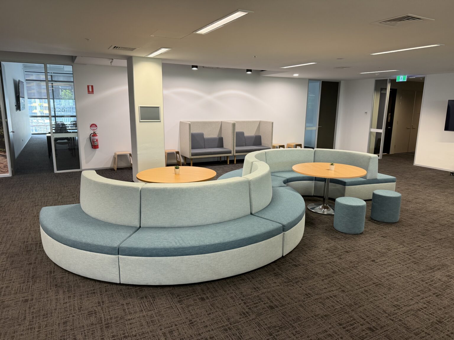 Teal curved modular breakout seating for a workplace by EFI Furniture