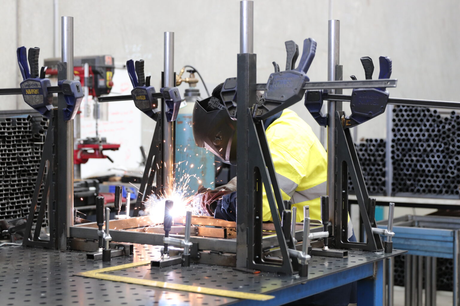 MIG welding a custom steel frame at EFI Furniture