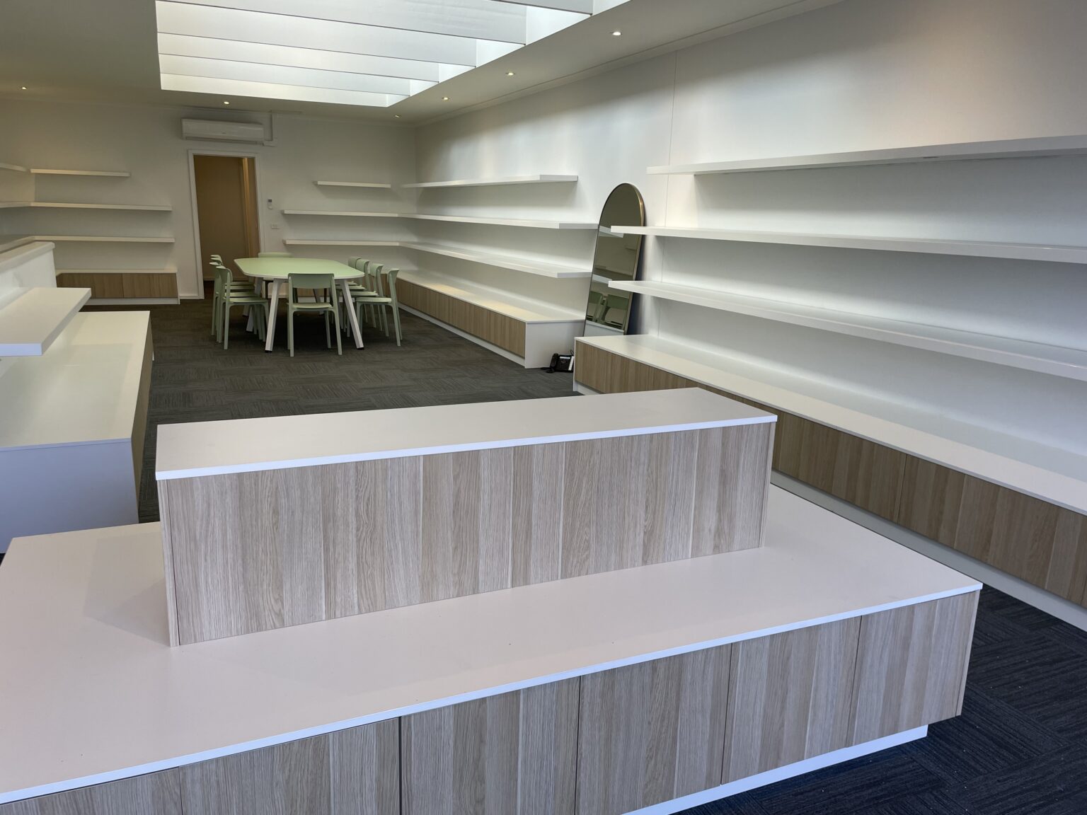 Woodgrain retail counters and wall shelving fit-out by EFI Furniture
