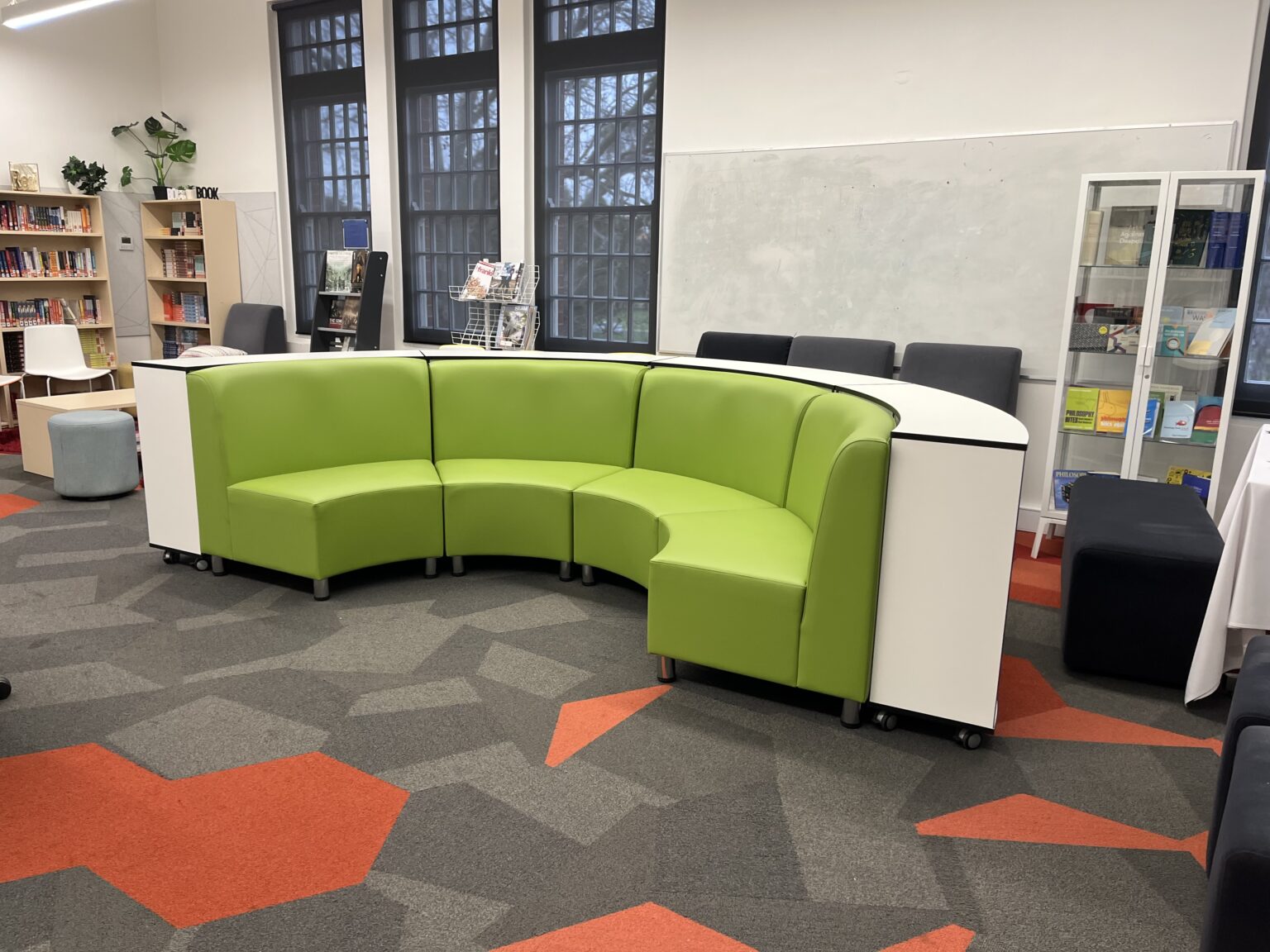 Green curved modular lounge seating in a school library by EFI Furniture